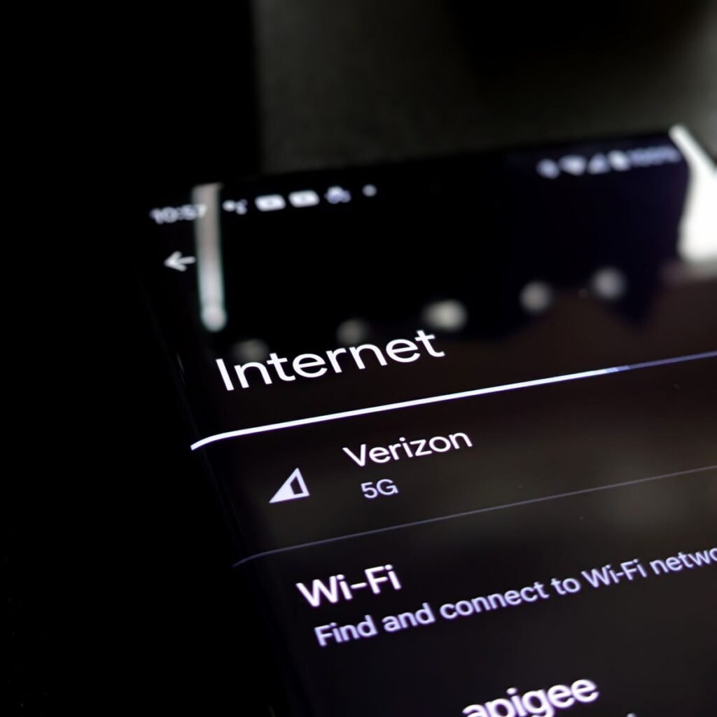Photo by Obi Onyeador Close-up of a smartphone screen displaying internet connection details with Verizon 5G and Wi-Fi options.