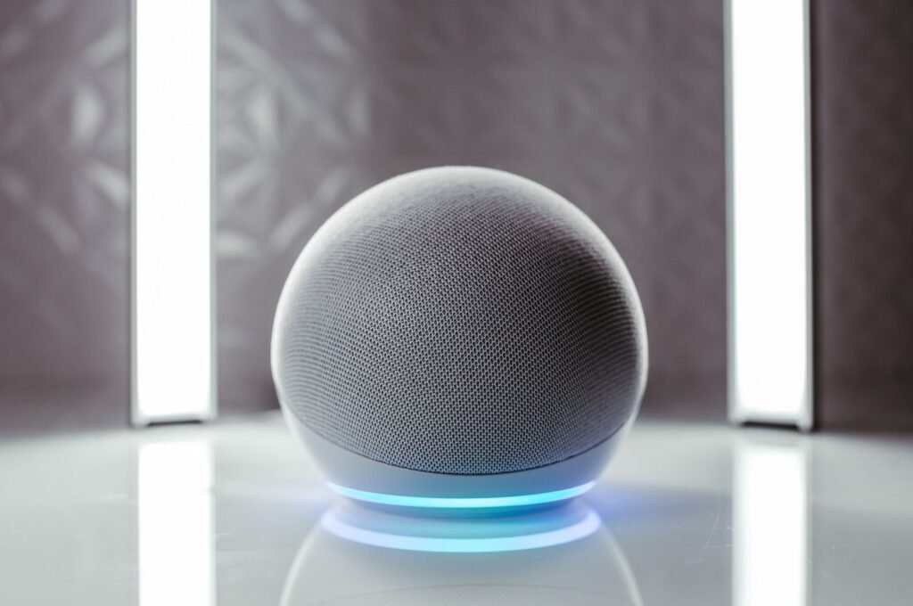 Photo by Jonathan Borba Close-up of a spherical smart speaker with illuminated base, perfect for modern interiors.