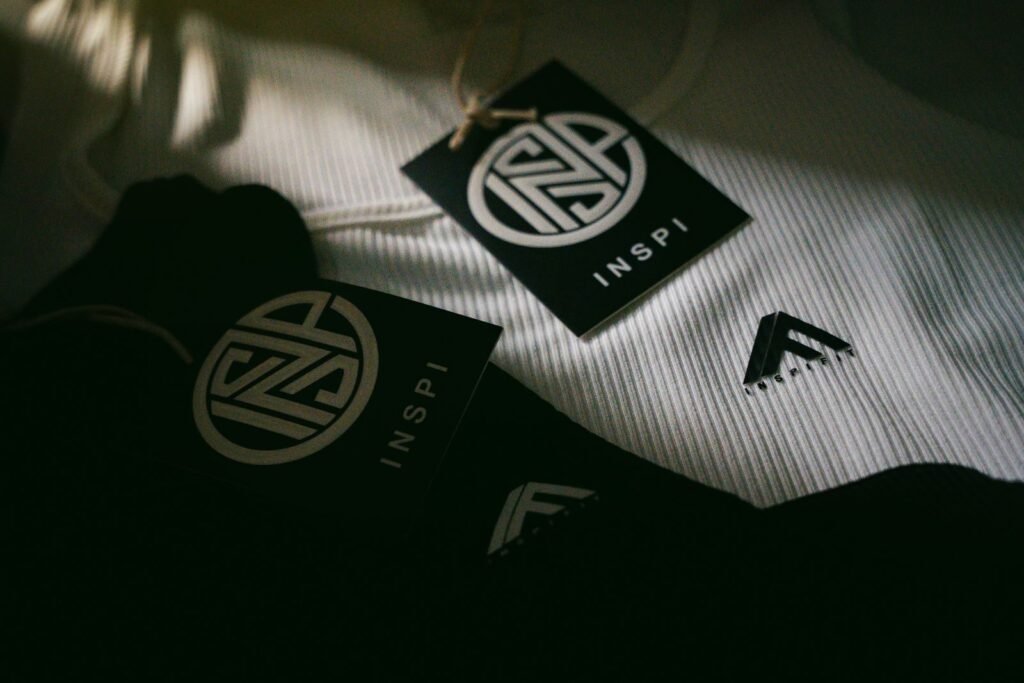 Detailed photo of fashion labels and logos on textured fabric in dim lighting.