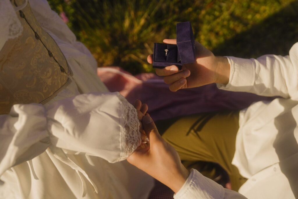 Vintage-inspired outdoor proposal with engagement ring and romantic atmosphere.