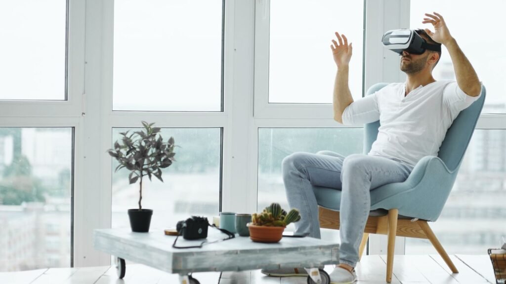Photo by Vitaly Gariev An adult man enjoying virtual reality with VR headset in a modern indoor setting.