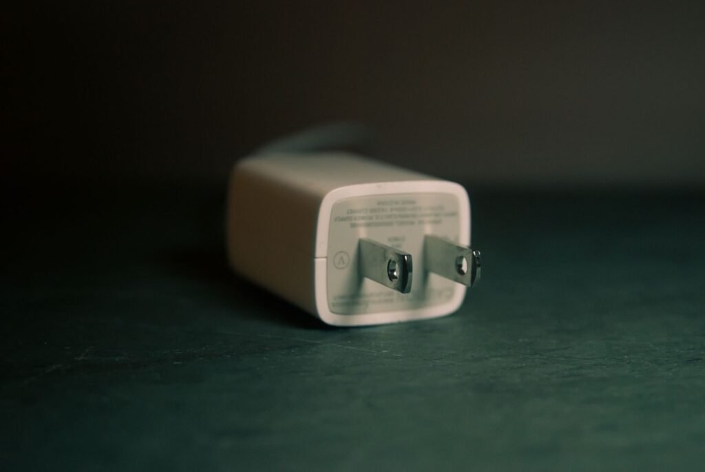 Photo by Steve A Johnson A focused view of a white wall charger plug lying on its side indoors.